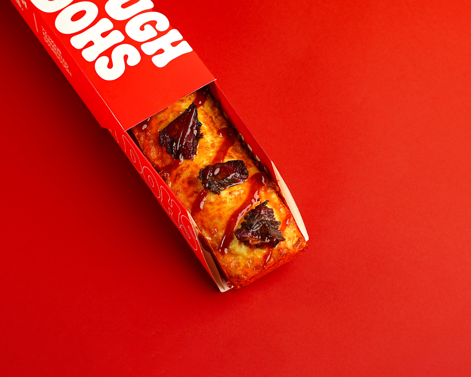 Dough Dohs Honey Brisket pizza in its branded red box